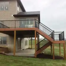 a brown house with black railing
