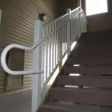white railing on brown stairs